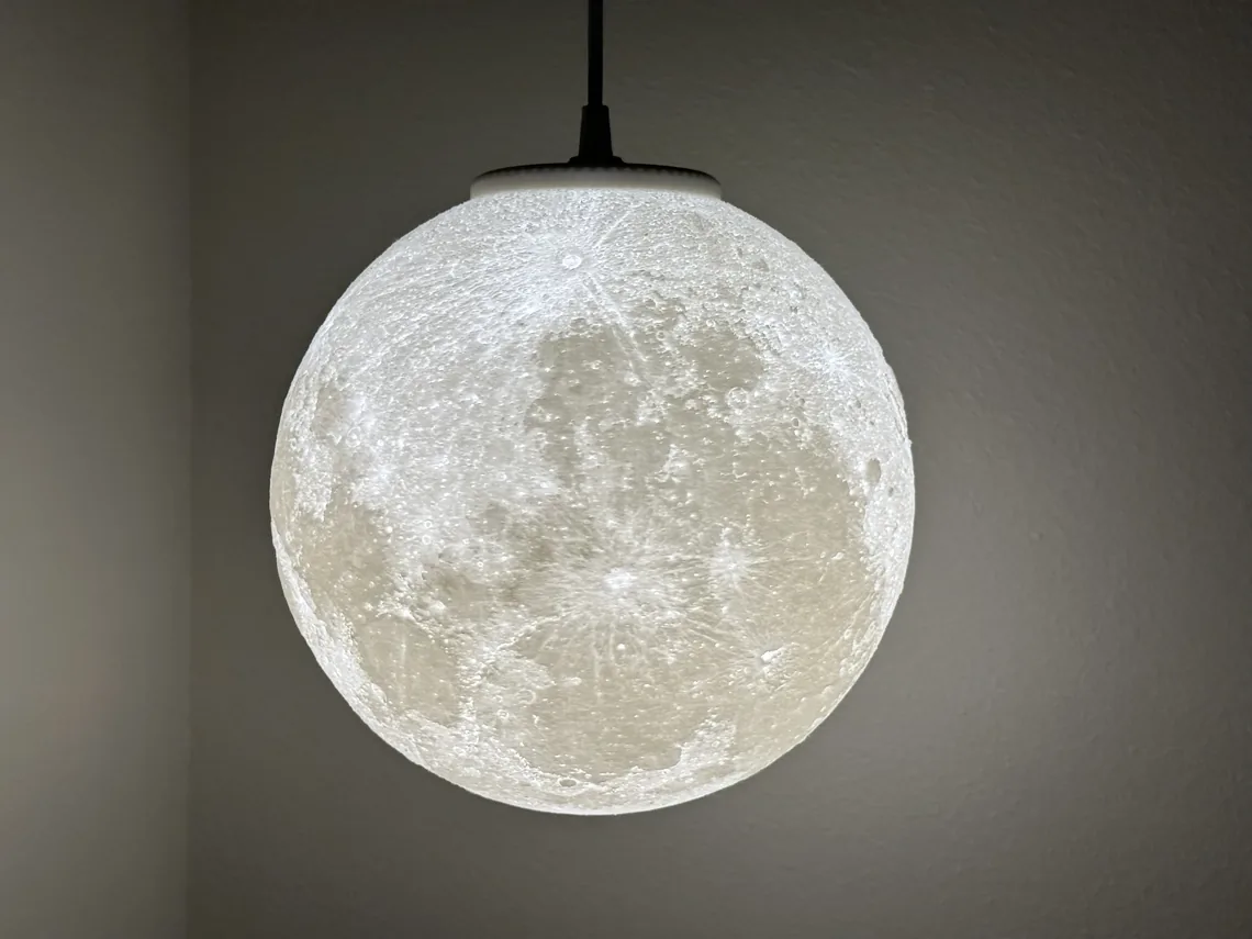 The 10 inch hanging moon lit on its black cord in a corner